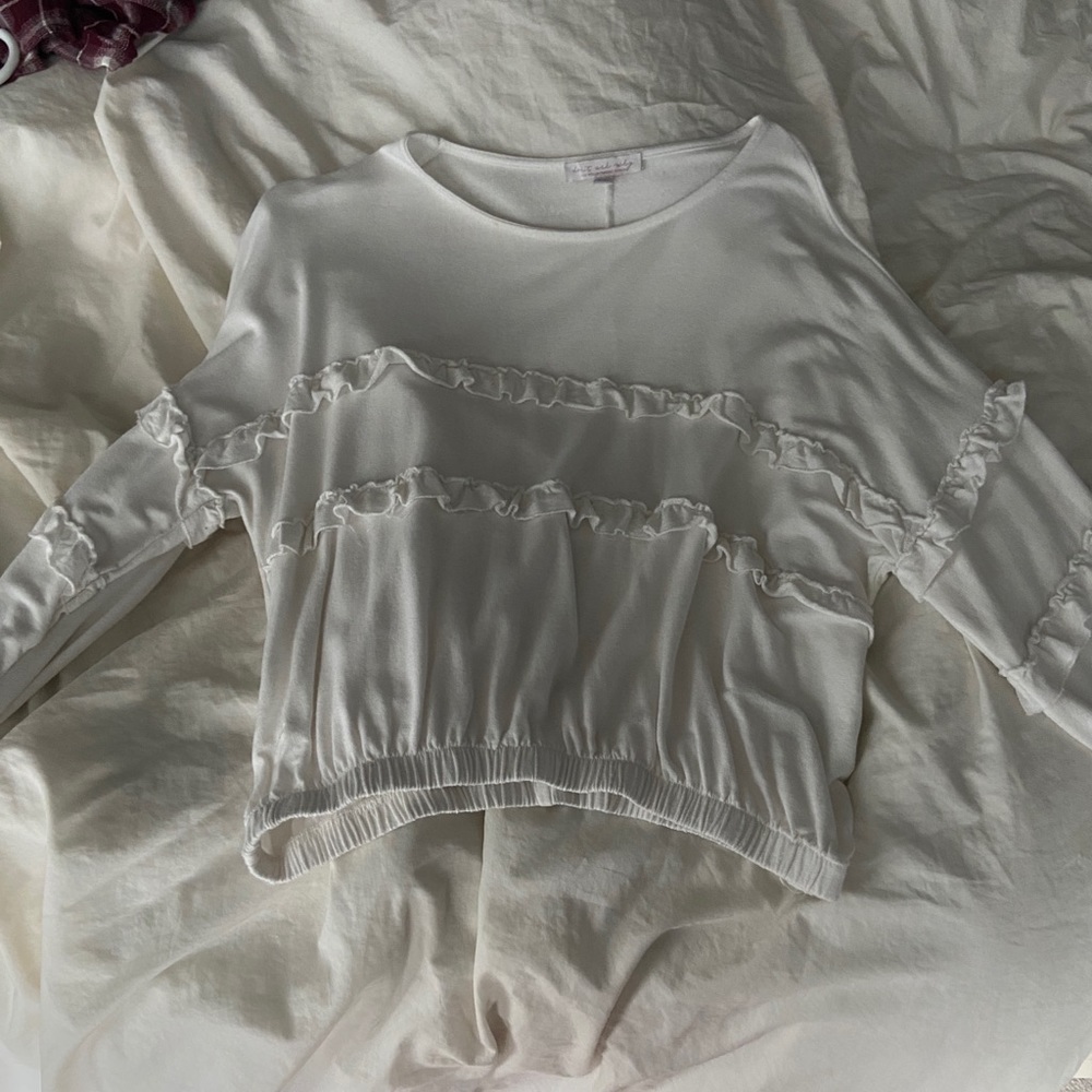 A white ruffled Long sleeve shirt